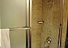 Upstairs bathroom with shower enclosed bath tub.