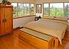 The master bedroom upstairs has an Asian-inspired look with a king tatami platform bed topped with a high-grade futon and feather mattress. This romantic room has beautiful views and a door leading out to the lanai.
