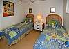 The second bedroom is furnished with comfortable twin beds.
