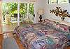 The master bedroom has a king bed and doors that open to the lanai.