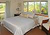 One wing on the 1st floor of the house has a guest room with a queen bed, private bath, its own TV, and lots of windows to let in the landscaping.