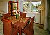 The dining area of the Ohana has a comfortable table and looks directly out to the pool and backyard.