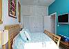 Flat screen TV and closet space in the bedroom