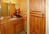 The vanity area has granite counters and upgraded cabinets.