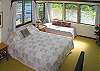 The master bedroom is upstairs, private from the rest of the house. It has a half bath attached and nice views out to the water.