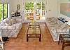Terra cotta tiled floors and French doors open onto the outdoor lanai giving the living area a light, open feel.