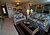 Light tropical furnishings and a tile floor lead to the lanai and that awesome view!