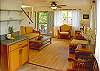 Tiled and hardwood floors, bamboo furnishings, a flat-screen TV, and lots of light make for a comfortable and stylish living area.