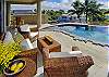 Relax poolside on the large lanai with comfortable furniture and nice views before taking a swim.