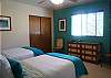 The third bedroom has two twin beds and garden views.