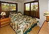 A queen bed and tropical decor make up the master bedroom, with a ceiling fan for those warm nights.
