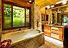 The master bath has a large walk-in shower and a Jacuzzi spa.