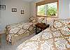 Honu's Hideaway features beautiful linens throughout, including this twin-bedded guest room.