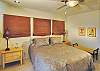 The middle floor off the great room has another bedroom with a queen bed and its en suite bath. Love those linens!