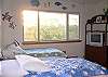 The other wing on the 1st floor has a charming bedroom with a Hawaiian flair. Kids will love the twin beds and their own TV and private bath.