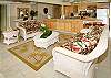 A view back over the living area to the fully equipped kitchen with extra-large counters and top-quality appliances.