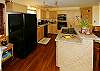 The fully equipped top-floor kitchen has a gas stove and a breakfast bar for casual dining.