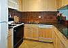 Wow! Granite countertops, tiled backsplash, fancy lighting, new cabinets, and all updated appliances make this kitchen one of the nicest in the complex!