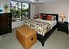 The large master bedroom has a queen bed with a Beautyrest pillowtop mattress, windows to the garden, and an en suite bath.