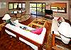 The upstairs living area has exotic wood treatments, a tranquil oceanfront view, and a TV with DVD for those quiet nights in paradise.