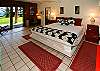 The Akahi Suite on the lower level has a comfortable king bed, private bath, and an adjoining bedroom with split King bed and area with cable TV and telephone.