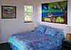 This bedroom with a queen bed opens directly onto the front lanai through sliding doors. Fall to sleep listening to the sound of the ocean and wake up to those spectacular sunrises without getting out of bed!