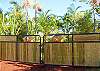 The elegant bamboo entrance gate welcomes you to an acre of tropical splendor at Maluhia Hale!