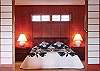 The elevated upstairs master bedroom has a Far East flair.