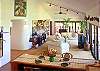 The large open living room, or great room, offers expansive ocean and mountain views from many sliders and windows.