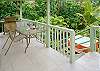 The back lanai offers privacy, with a barbecue grill, seating area, and steps down to your own private jungle hot tub!