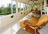 The enclosed upstairs lanai of Champagne Cove is light and bright and offers wonderful views of the ocean and whales (in season). You can see the dining area at the far end of this photo.