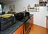 The kitchen is open to the living area, but the counter also serves as a breakfast bar when eating in.