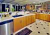 What a great kitchen! Top-of-the-line appliances, cabinets, and dishes.