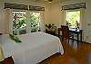 On the opposite side of the house is another bedroom with views to the garden, a queen bed, and a desk with high-speed Internet.