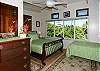 Ocean-view bedroom with queen sleigh bed and single bed.