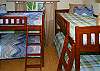 Bring the kids! There's room for each one in this small second bedroom with lots of beds.