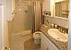 The light and tastefully designed bathroom with custom, artistic tiles.