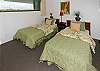 The second bedroom has 2 twin beds and a view of the Kilauea volcano.