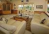 The top-floor living area has nice light furnishings, keeping in mind your comfort and maximizing that great view.