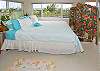 A second upstairs bedroom has a queen bed and a corner location with a great view of the pool and the ocean beyond.