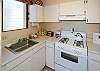 The convenient compact kitchen has everything you need including a gas stove and microwave.