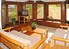 The living area has rich woods and new bamboo furnishings with lush tropical views out the windows.