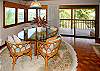 A closeup of the upstairs dining area looking out to the lanai and ocean.