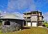 Both the large 3-story home and the separate open-air meditation room on the left make extensive use of rocks formed by the lava of the Big Island.
