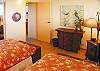The second bedroom has twin beds and a collection of wooden jungle animals for accents.