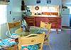 The dining area table with seating for 4 and the breakfast bar by the kitchen offer indoor dining options.