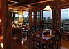 The warm interior is complemented by the blues and greens of the Hawaiian landscape through the windows.