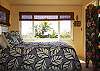A second upstairs bedroom has a queen bed and a corner location with a great view of the pool and the ocean beyond.