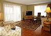 The Second Floor Living Room has stylish furnishings, ocean breezes, beautiful sunrises, and an outdoor lanai for enjoying the oceanfront location.