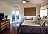 The Master Suite at Hau'oli Hale is bright and there is a TV for night time entertainment.